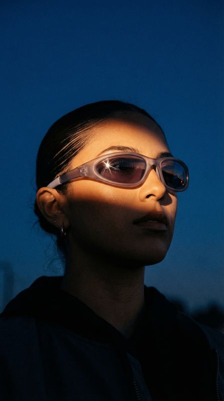a woman wearing sunglasses and a black shirt