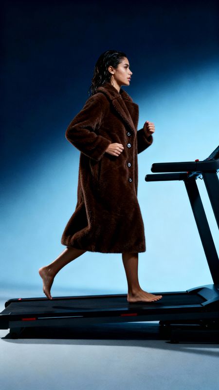 a woman is running on a treadmill