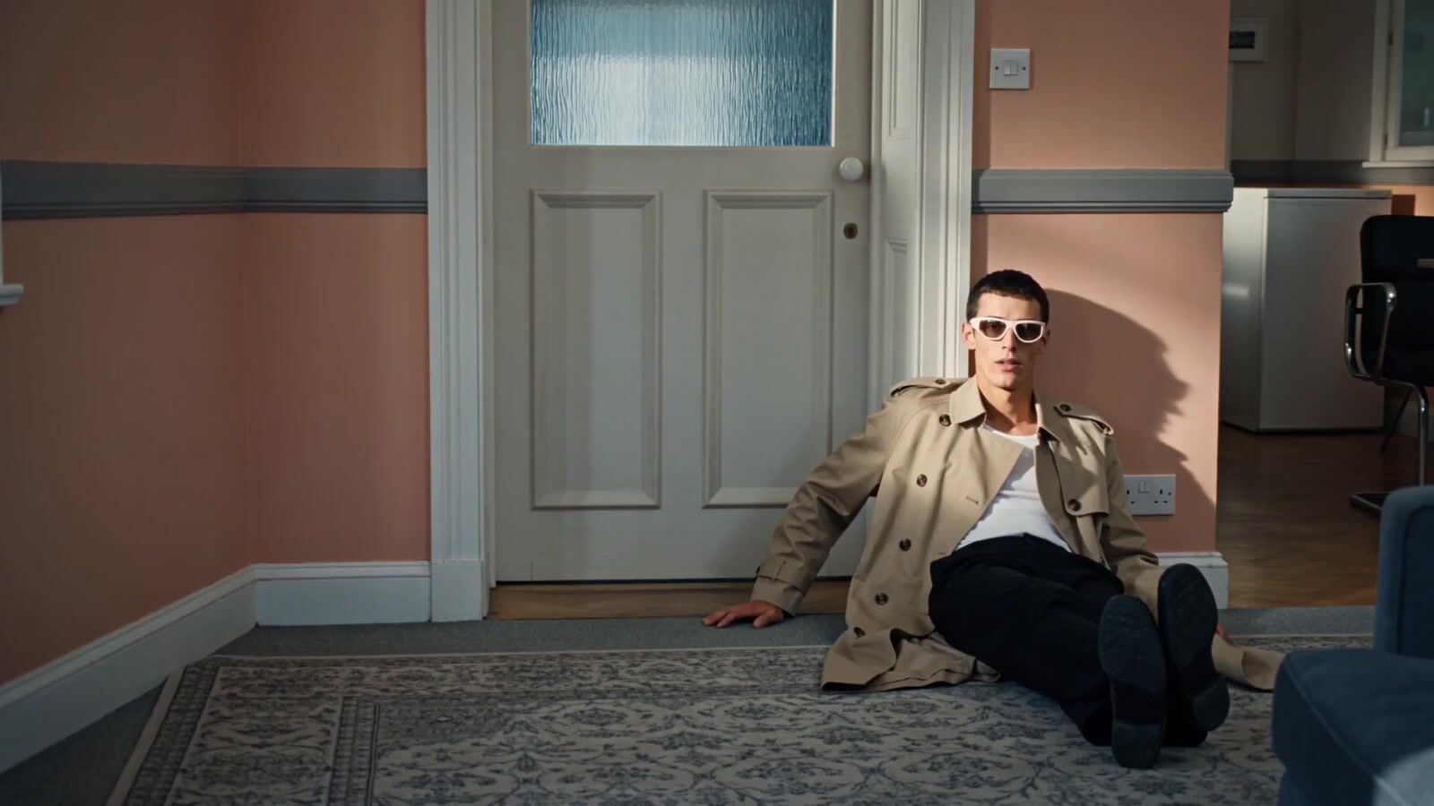 a man sitting on the floor in front of a door