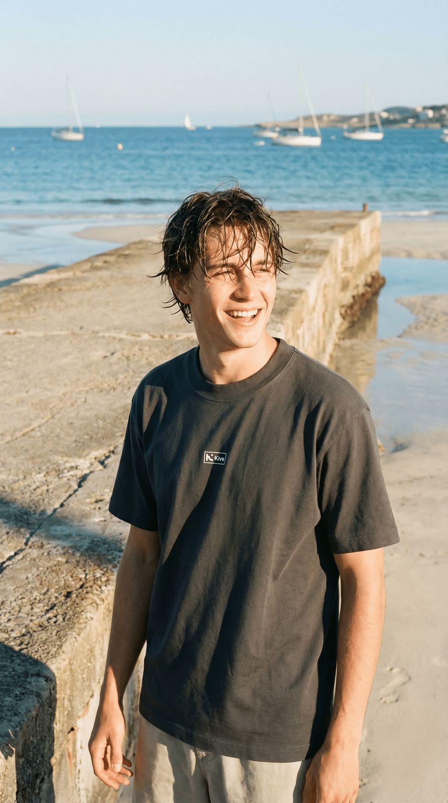 a man standing on a beach next to the ocean