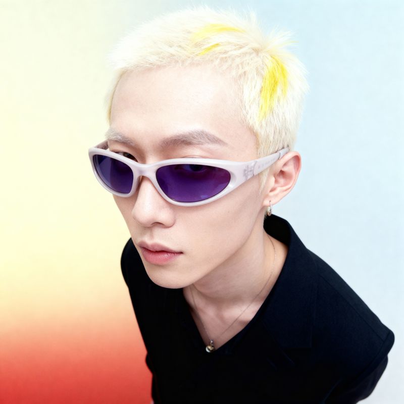 a young man with blonde hair and purple sunglasses