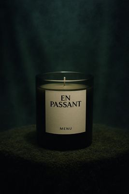 a lit candle sitting on top of a table