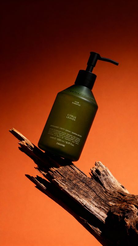 a bottle of liquid sitting on top of a piece of wood