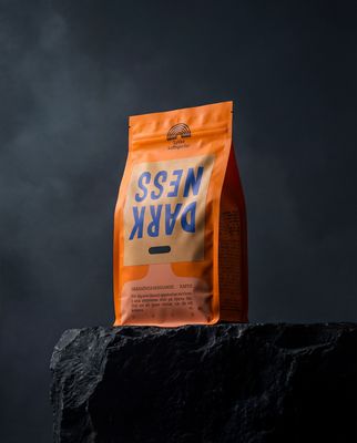 a bag of coffee sitting on top of a rock