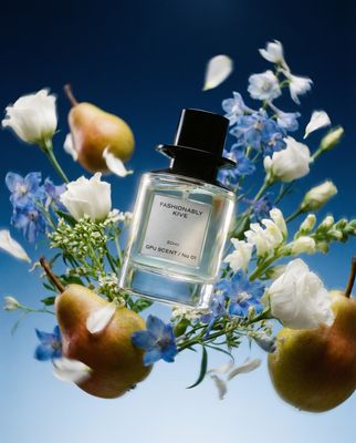 a bottle of perfume sitting on top of a bouquet of flowers