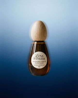 a bottle of liquid with a wooden stopper