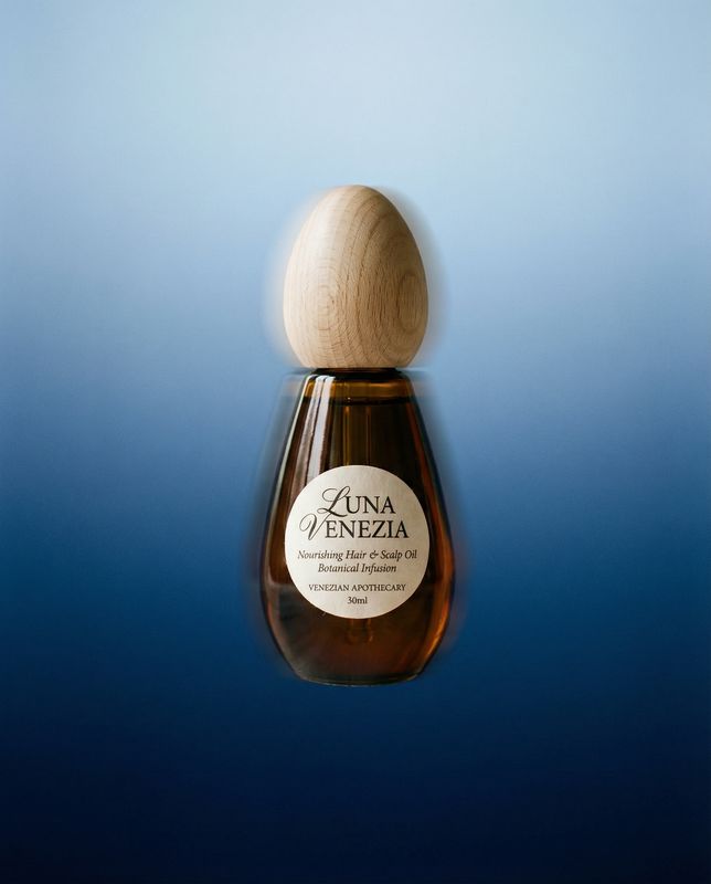 a bottle of liquid with a wooden stopper