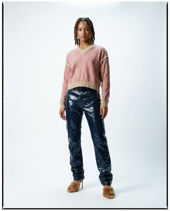 a woman standing in front of a white background