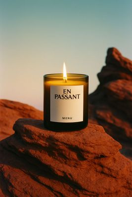 a candle sitting on top of a rock