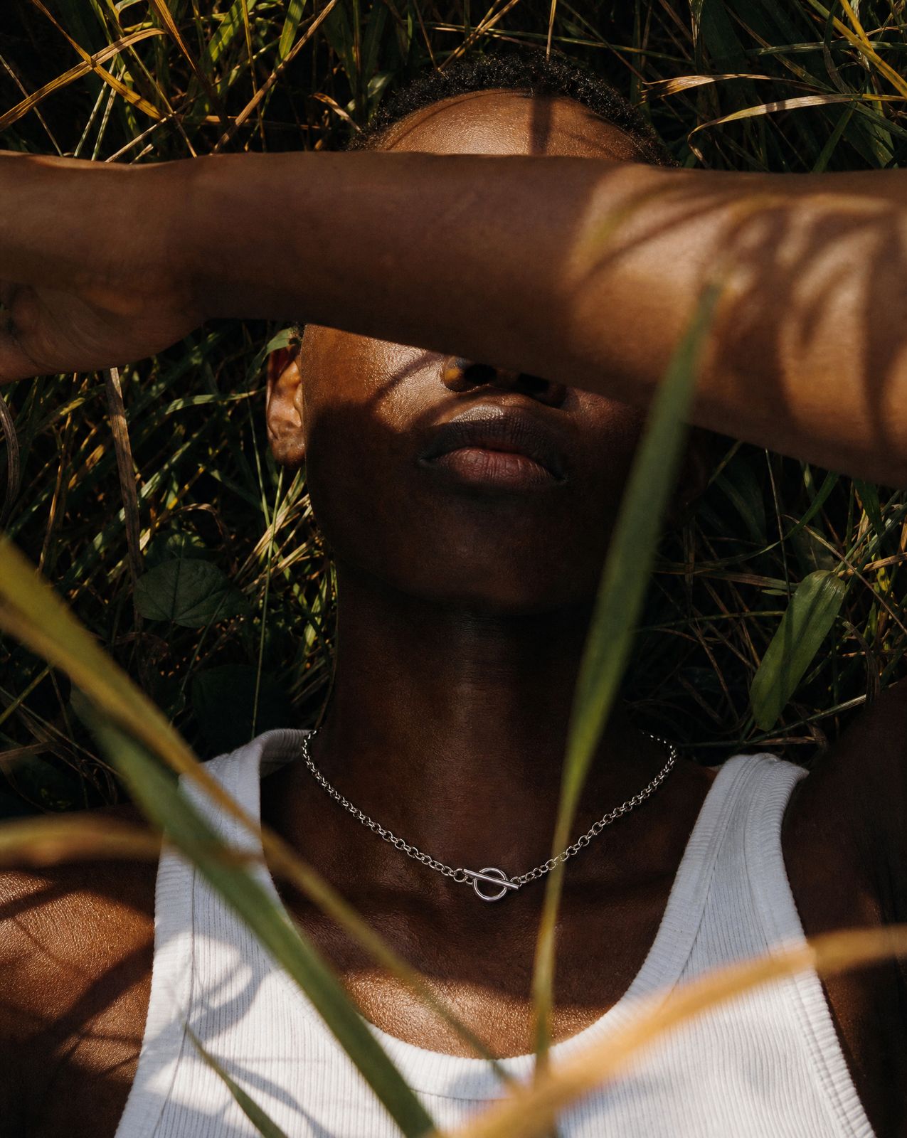 a woman in a white tank top is posing for a picture