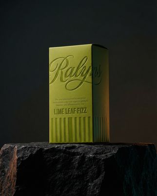 a green box sitting on top of a rock