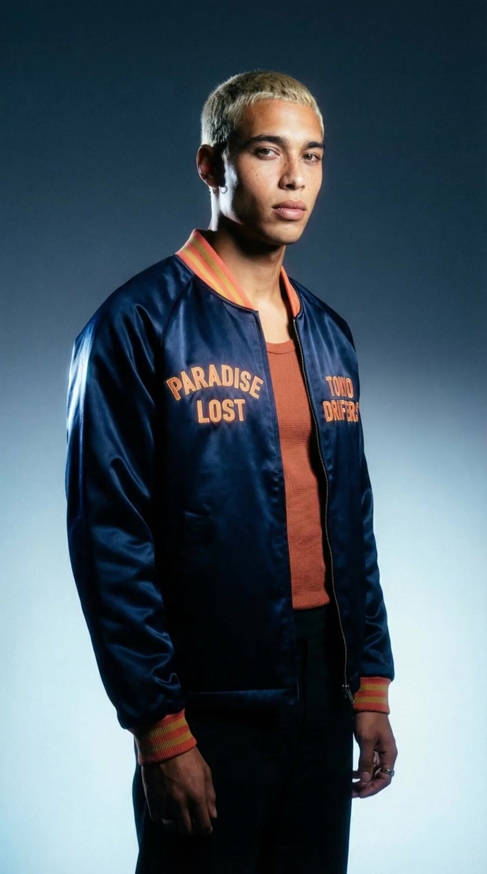 a man in a blue jacket is posing for a picture