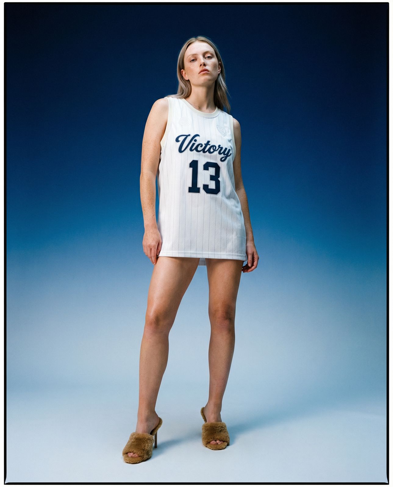 a woman in a white jersey posing for a picture