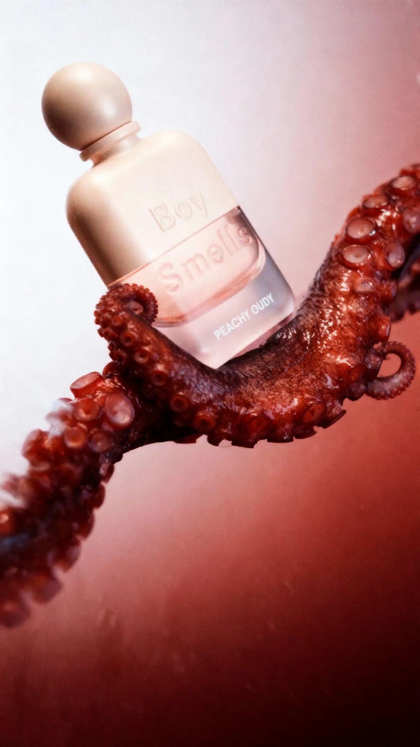 an octopus is holding a bottle of perfume
