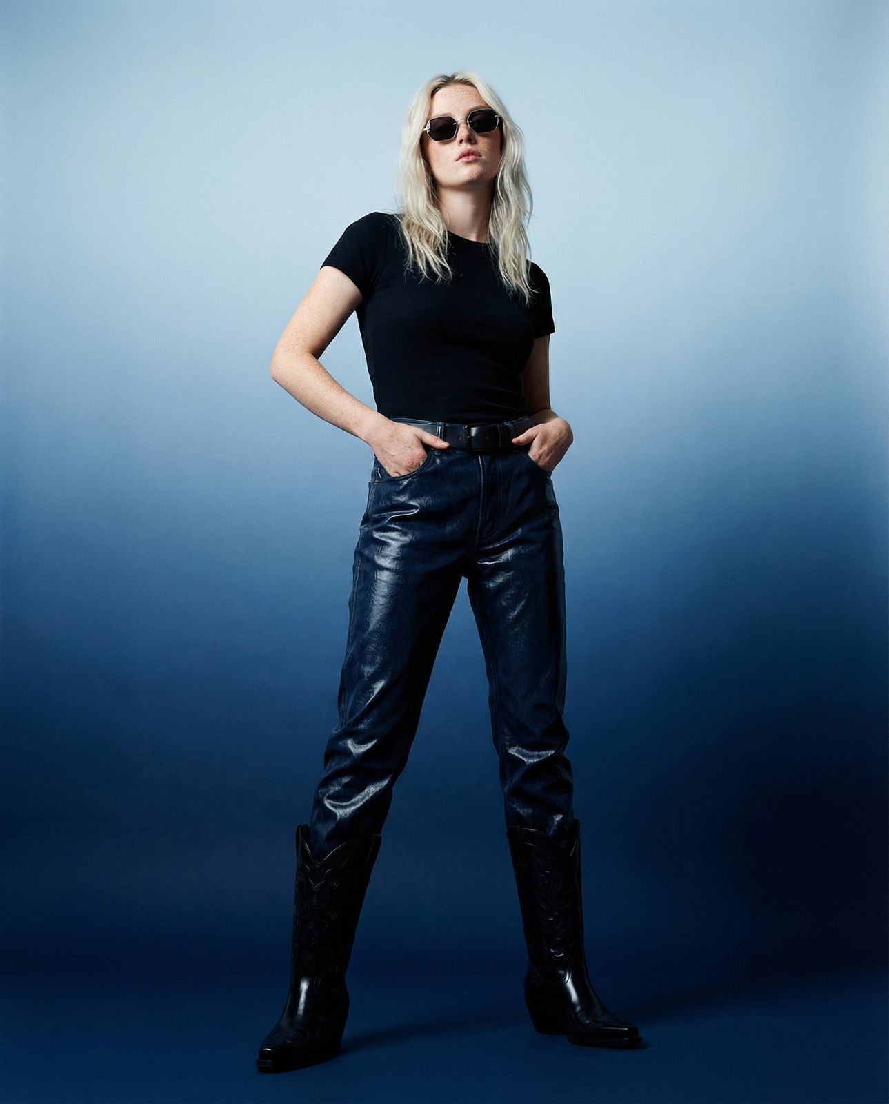 a woman in a black shirt and leather pants