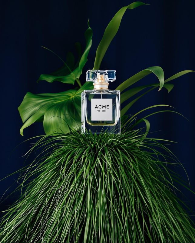 a bottle of acne on top of a plant