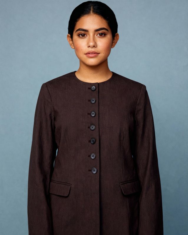 a woman standing in front of a blue background