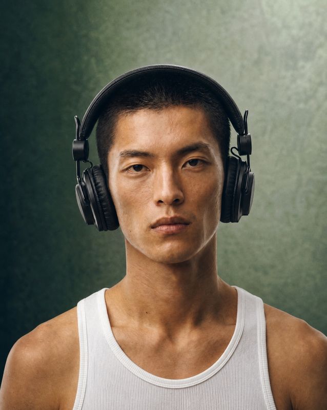 a young man wearing headphones and a tank top