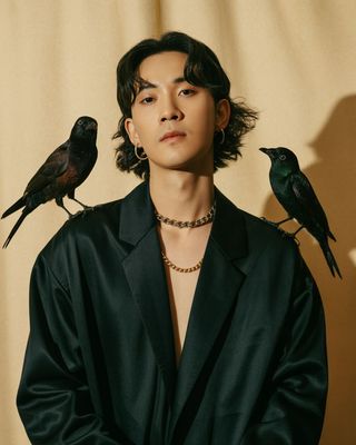 a man with two birds on his shoulders
