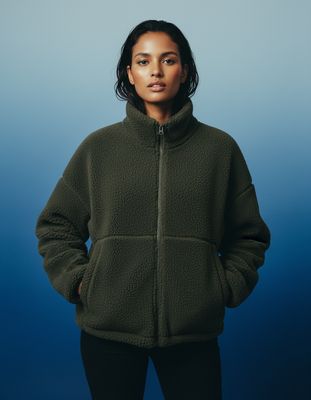 a woman standing in front of a blue background