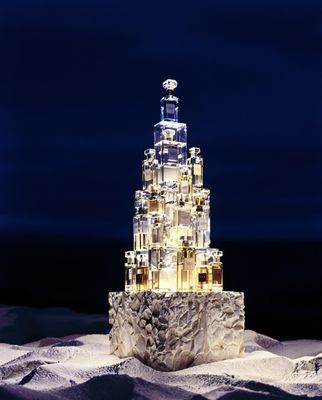 a very tall glass tower with a clock on top of it