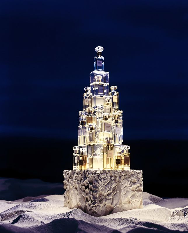 a very tall glass tower with a clock on top of it