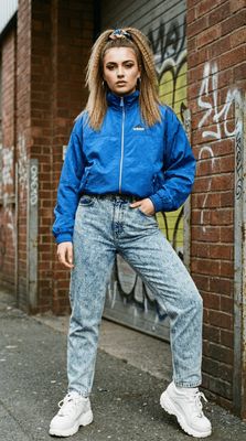 a woman standing in front of a brick wall