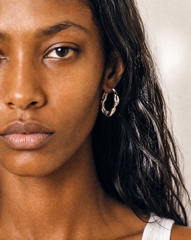 a close up of a person wearing earrings