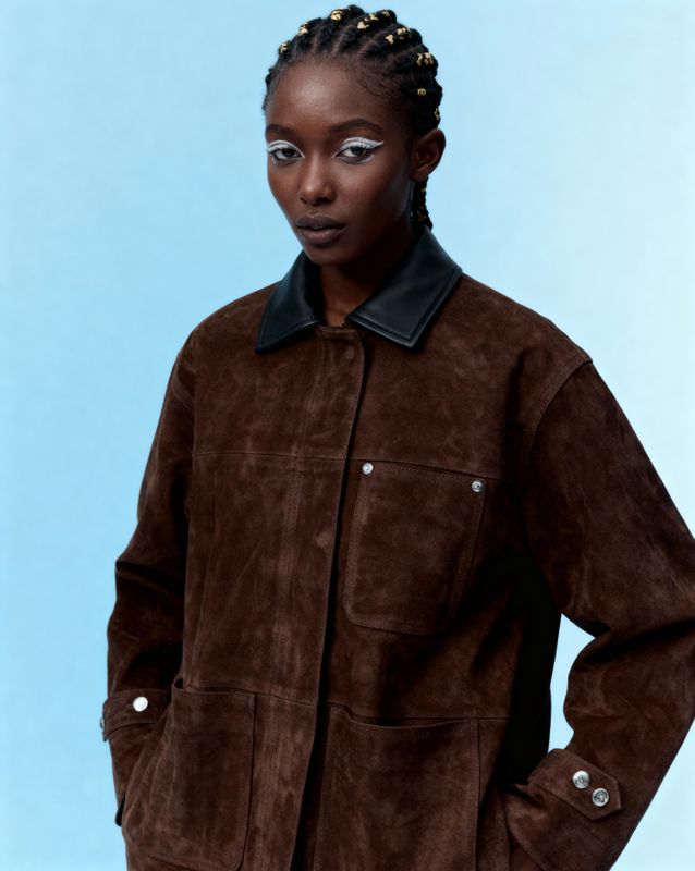 a woman standing in front of a blue background