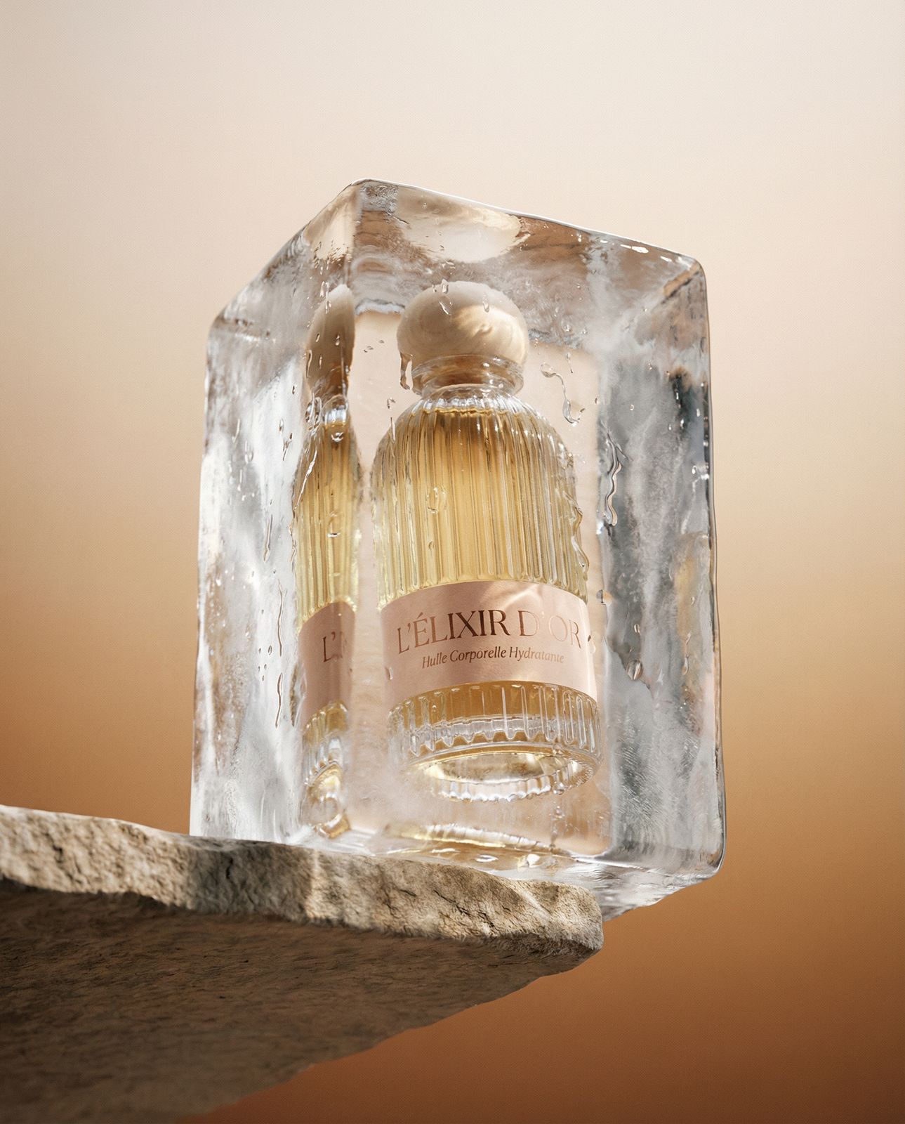 a bottle of perfume sitting on top of an ice block