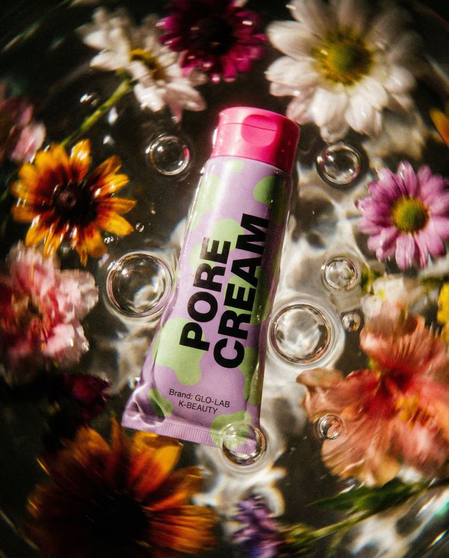 a tube of cream sitting on top of a bowl of water