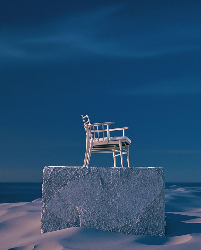 a chair sitting on top of a rock in the snow