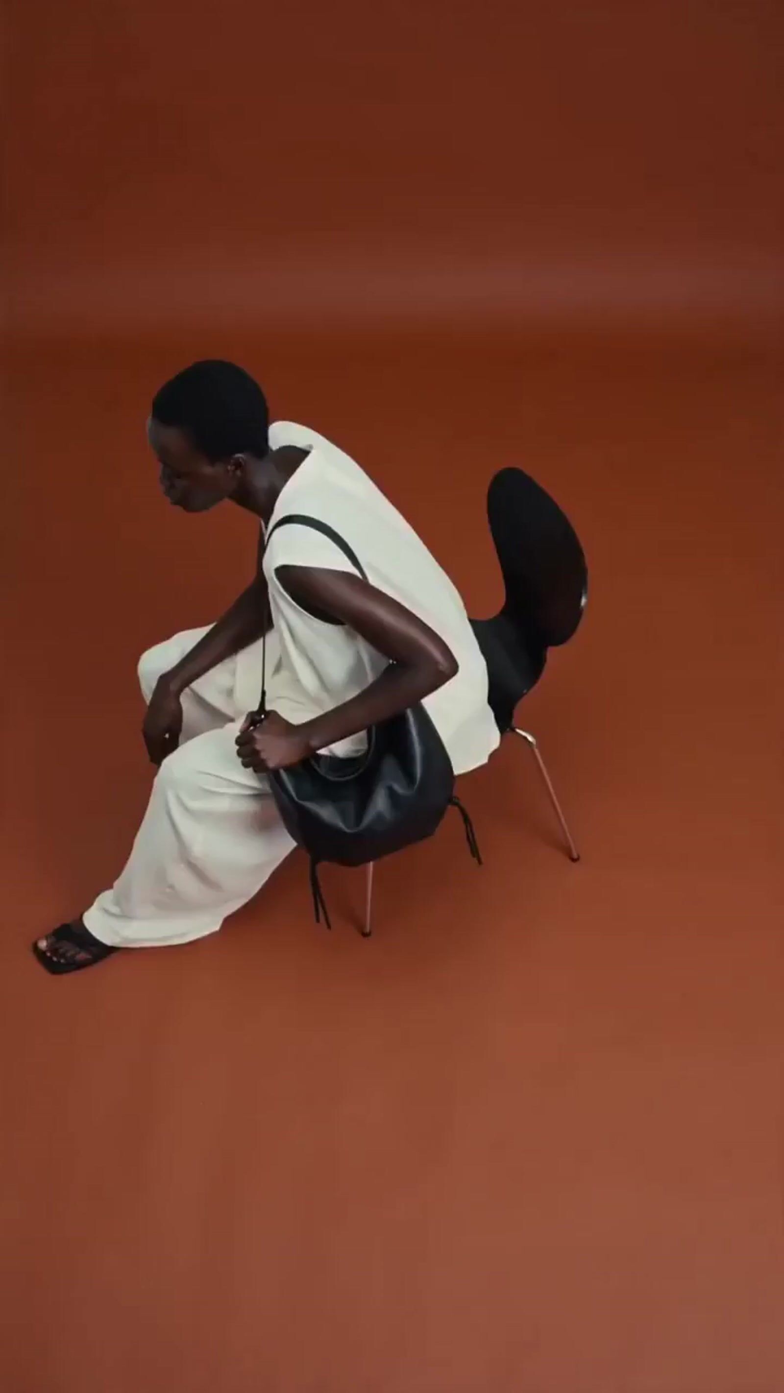 a man sitting on a chair on a red floor
