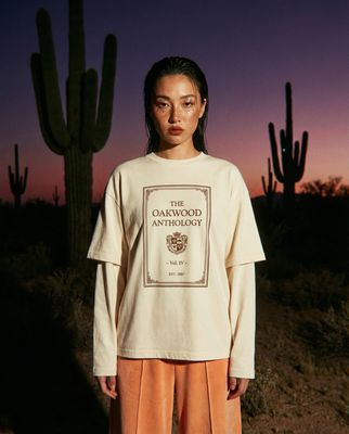 a woman standing in front of a cactus