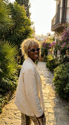 a woman standing on a cobblestone road