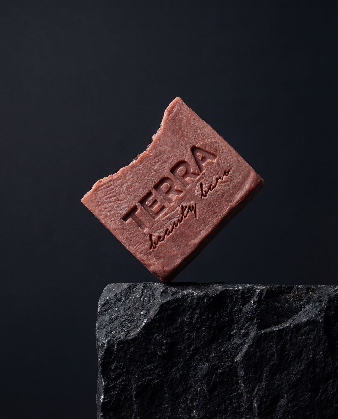 a piece of chocolate sitting on top of a rock