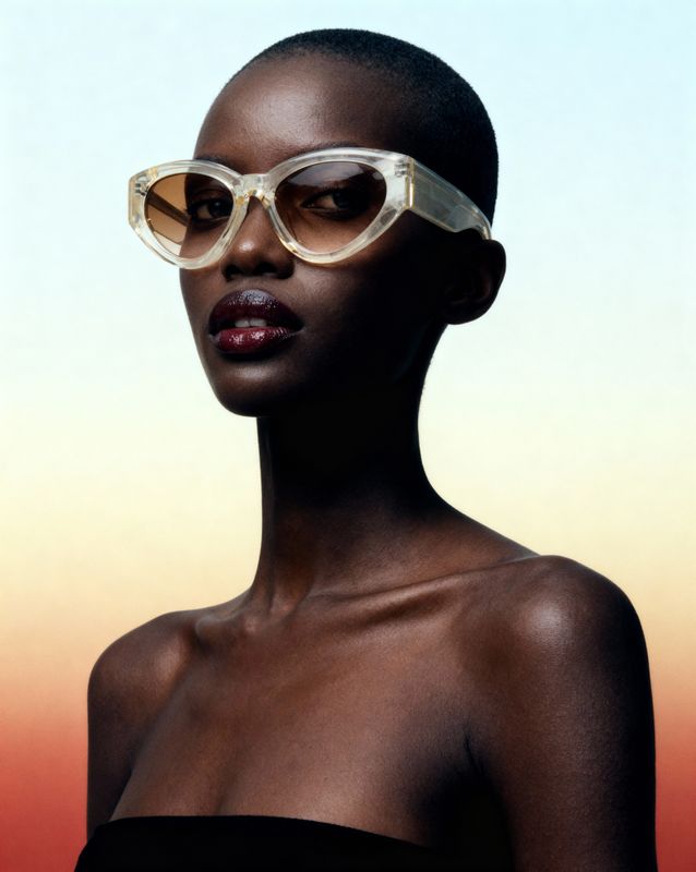 a woman wearing sunglasses and a black dress