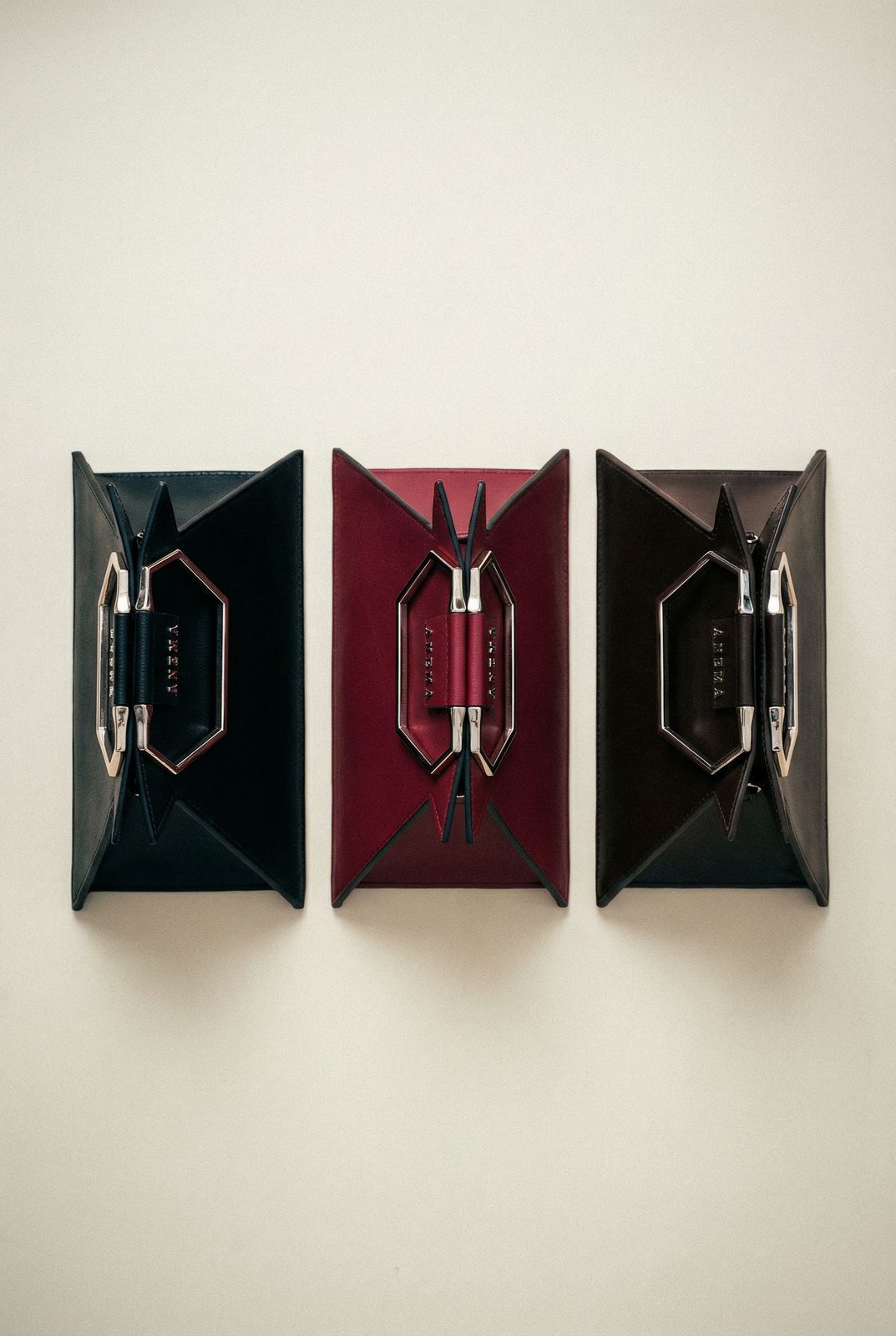 three pieces of art hanging on a wall