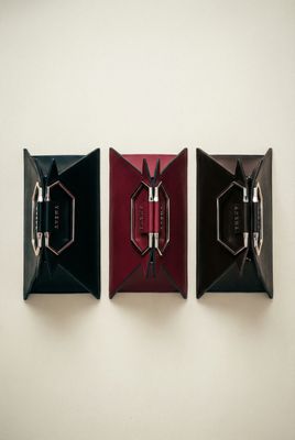 three pieces of art hanging on a wall