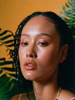 a woman with braids is looking at the camera