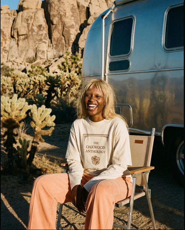 a woman sitting in a chair in front of a trailer