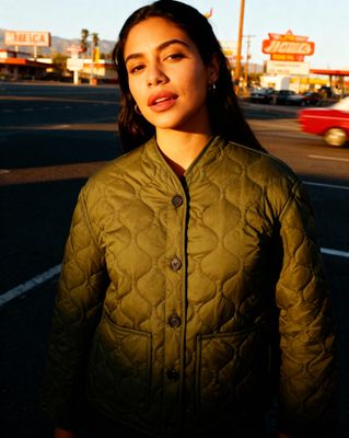 a woman standing in the middle of a street