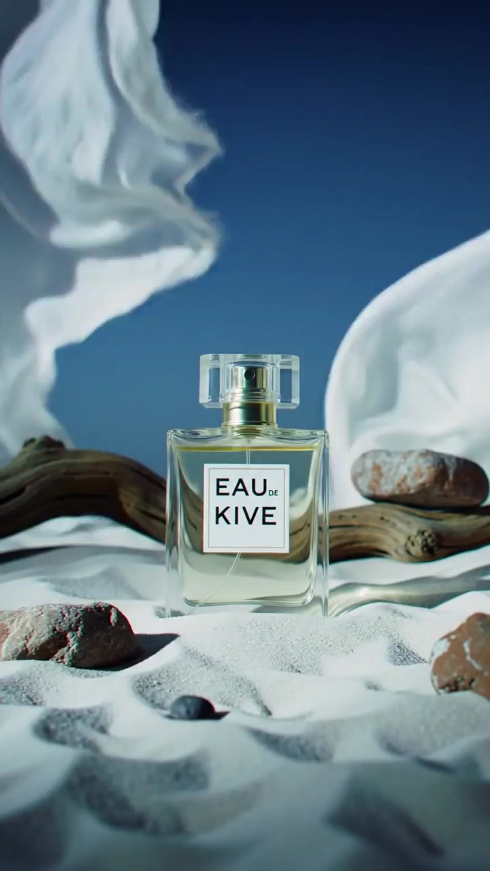 a bottle of eau kive sitting on top of a bed