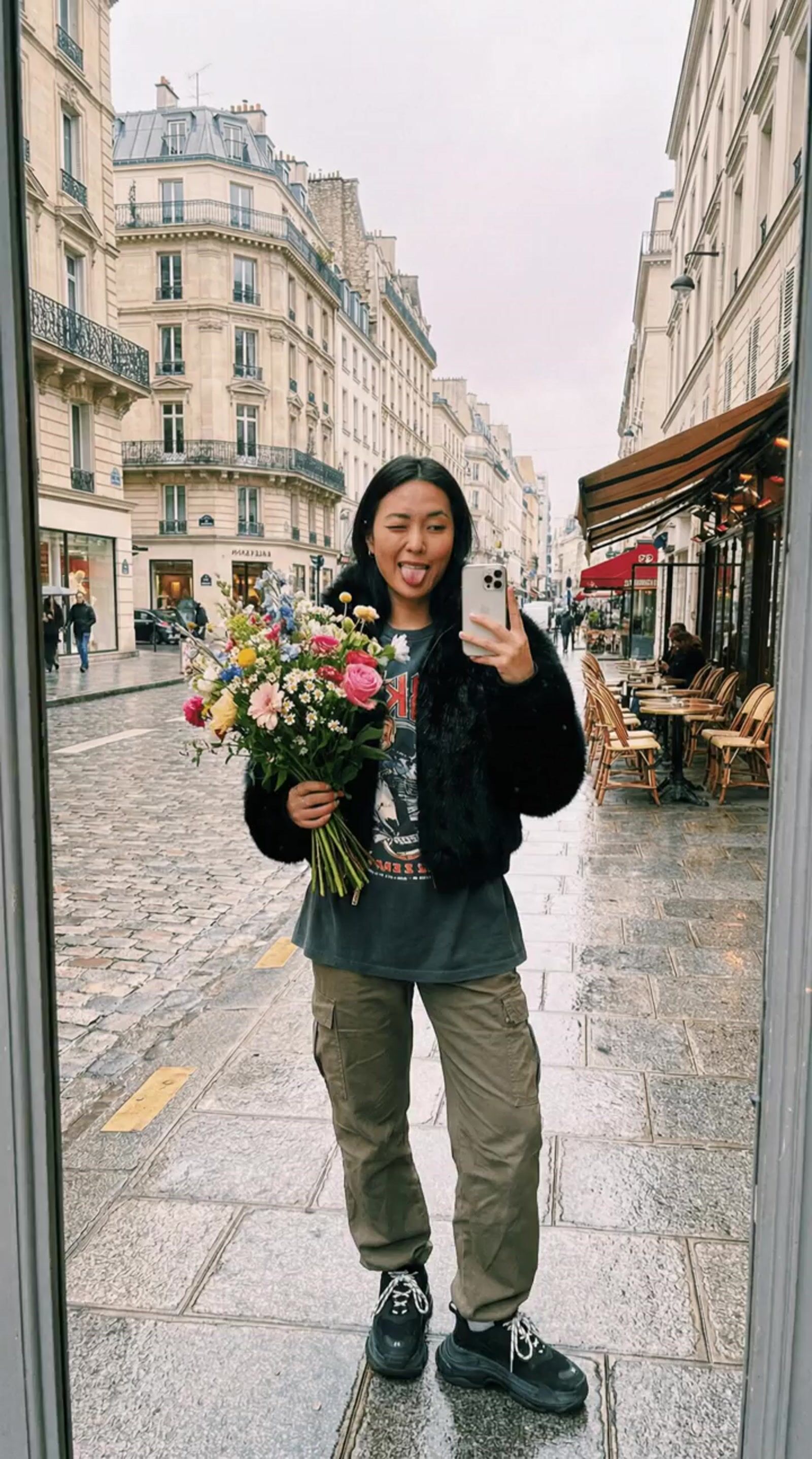 a woman taking a selfie with a bouquet of flowers