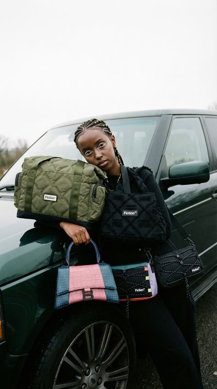 a woman sitting on the hood of a green car