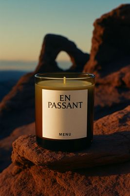 a candle sitting on top of a rock
