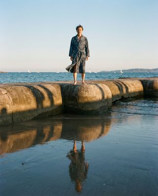 a man standing on a rock in front of the ocean