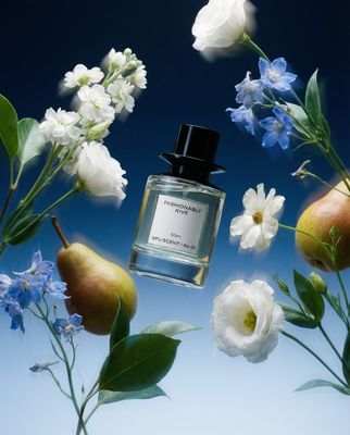 a bottle of perfume surrounded by flowers and pears