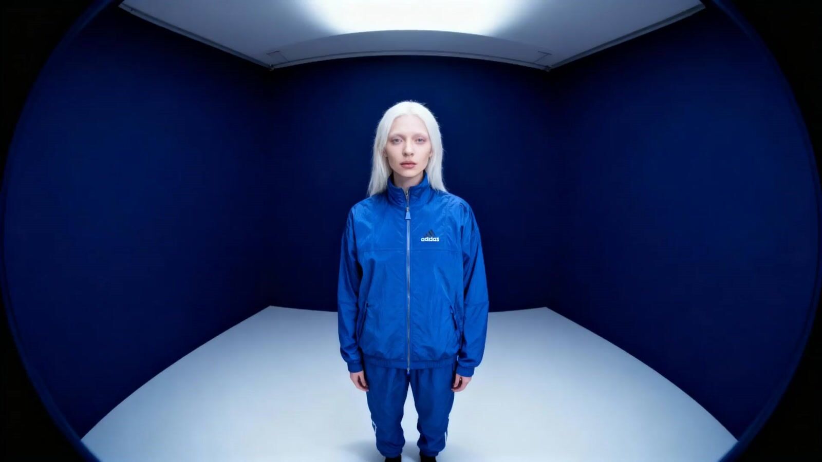 a woman with white hair standing in a room