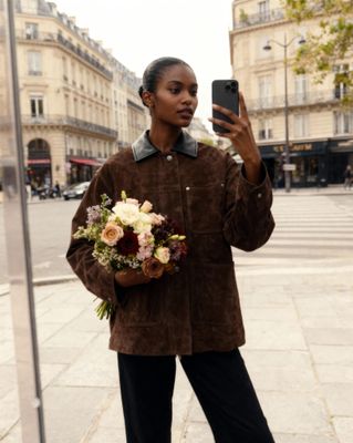 a woman taking a picture of herself with her cell phone